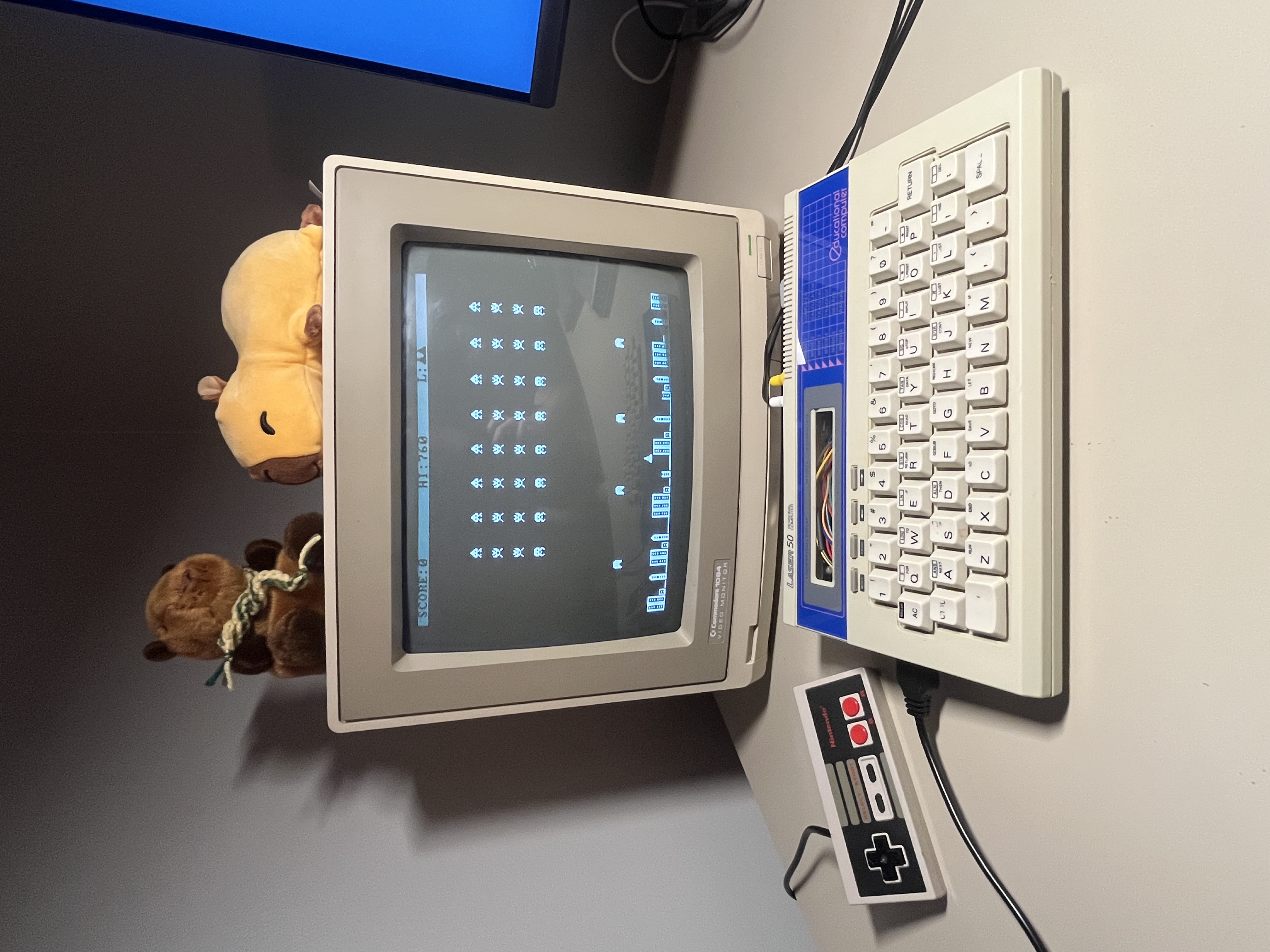 Built-in Space Invaders clone running on the Daisy/1, shown on a Commodore 1084 monitor with an NES controller alongside