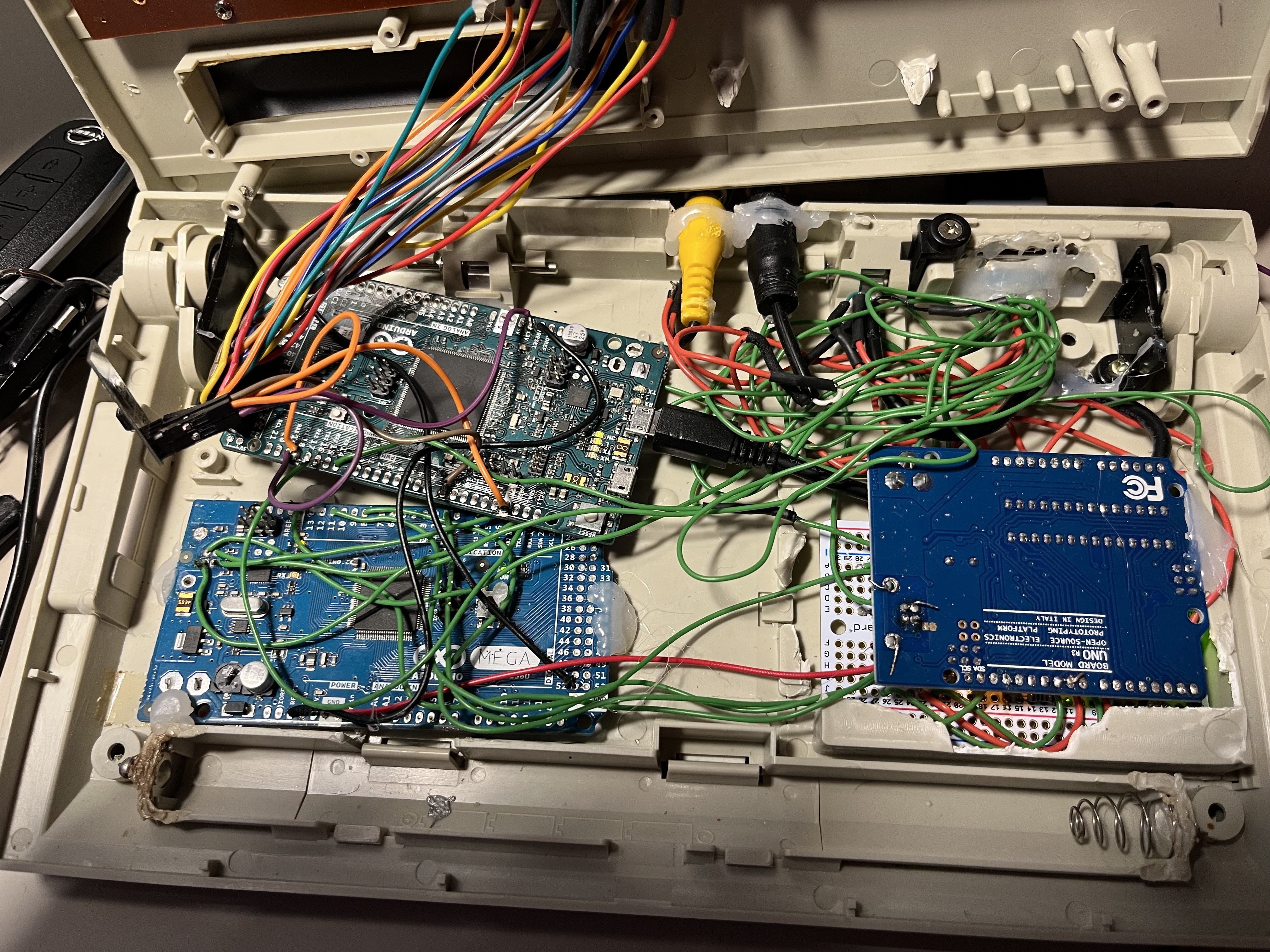 Inside the case: three Arduinos, jumper wire spaghetti, RCA jacks